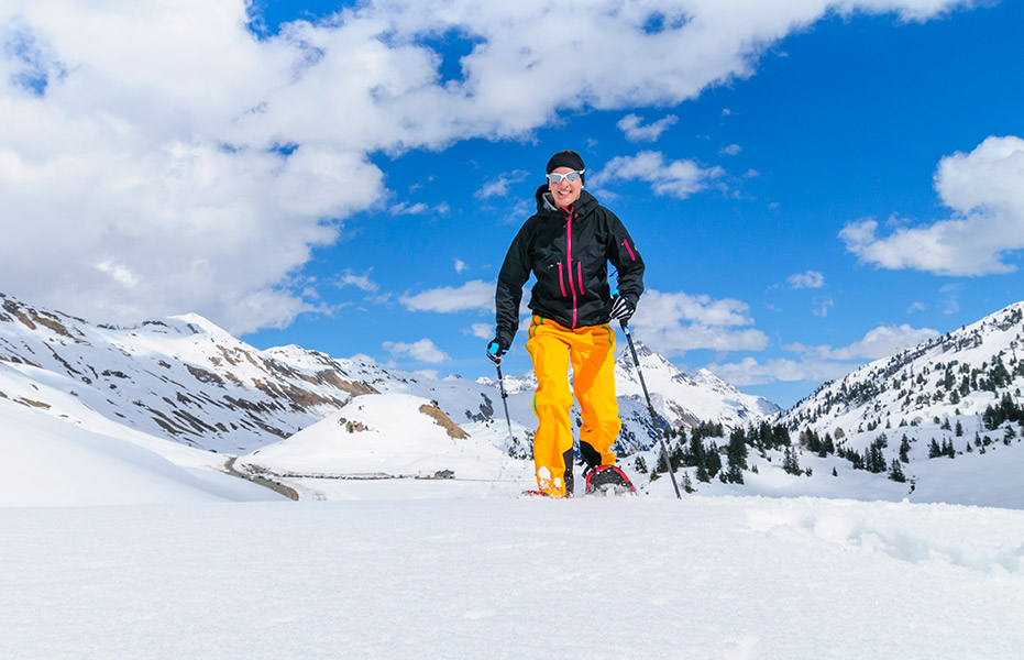 Mann beim Wandern mit Schneeschuhen